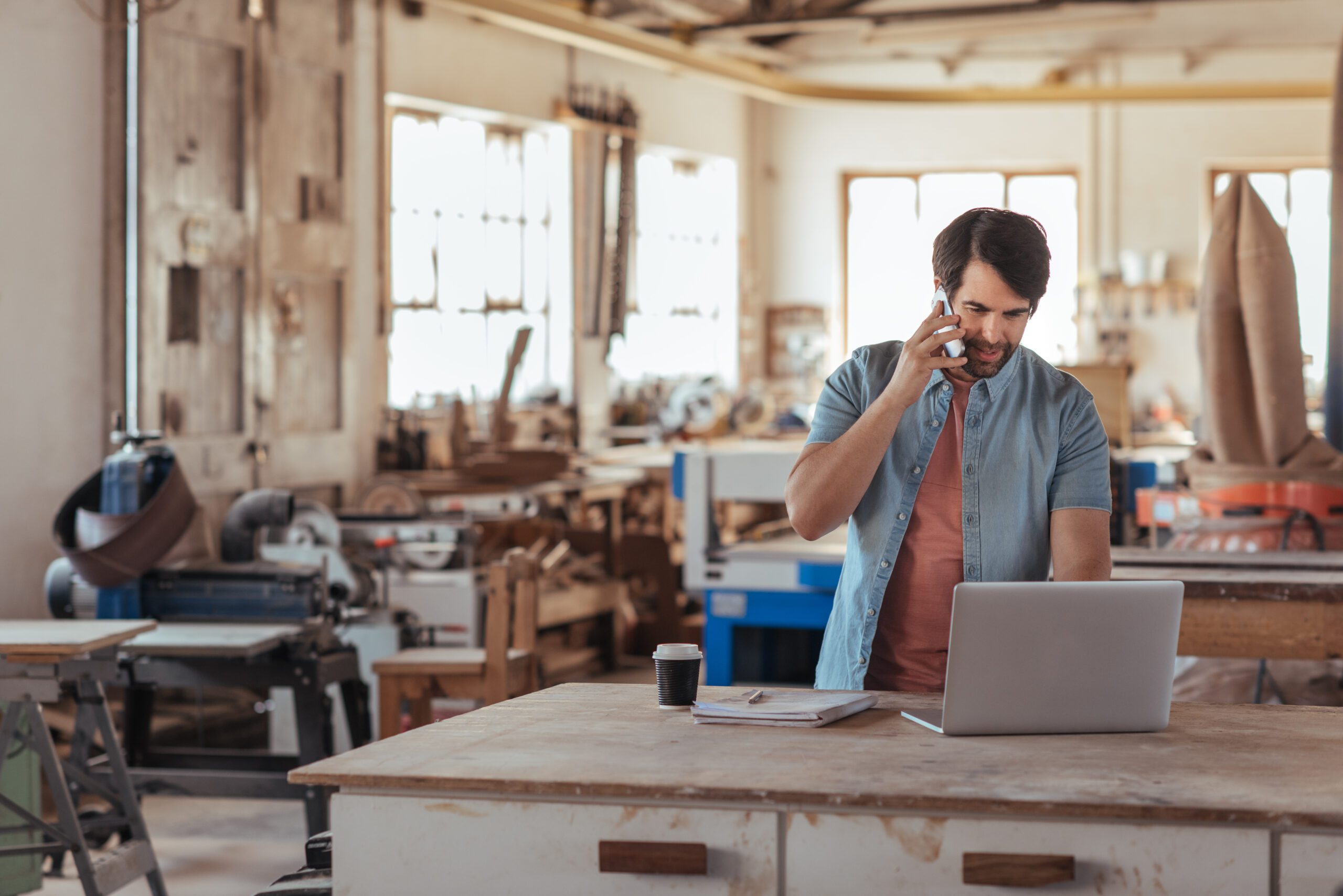 Man on PC in a woodworking shop