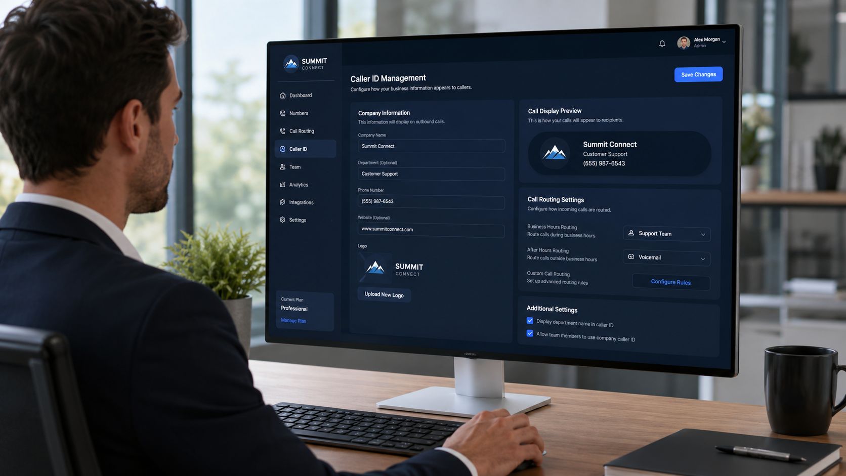 A professional man at his desk configuring caller ID management settings on a large computer monitor.
